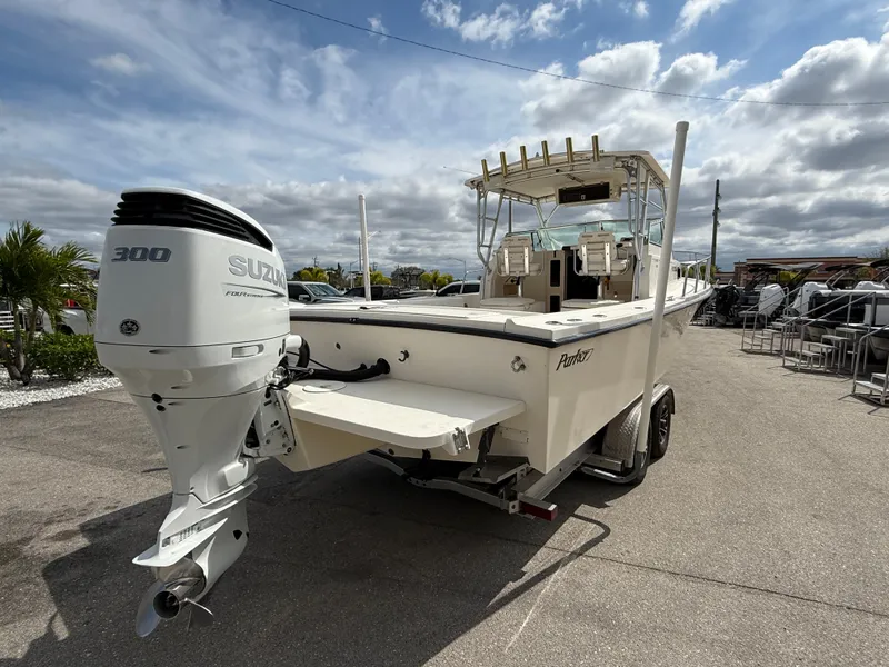 Slide: The Image of 2005 Parker 2510 Deep Vee Walkaround boat with Suzuki 300 engine, parked outdoors. - 7