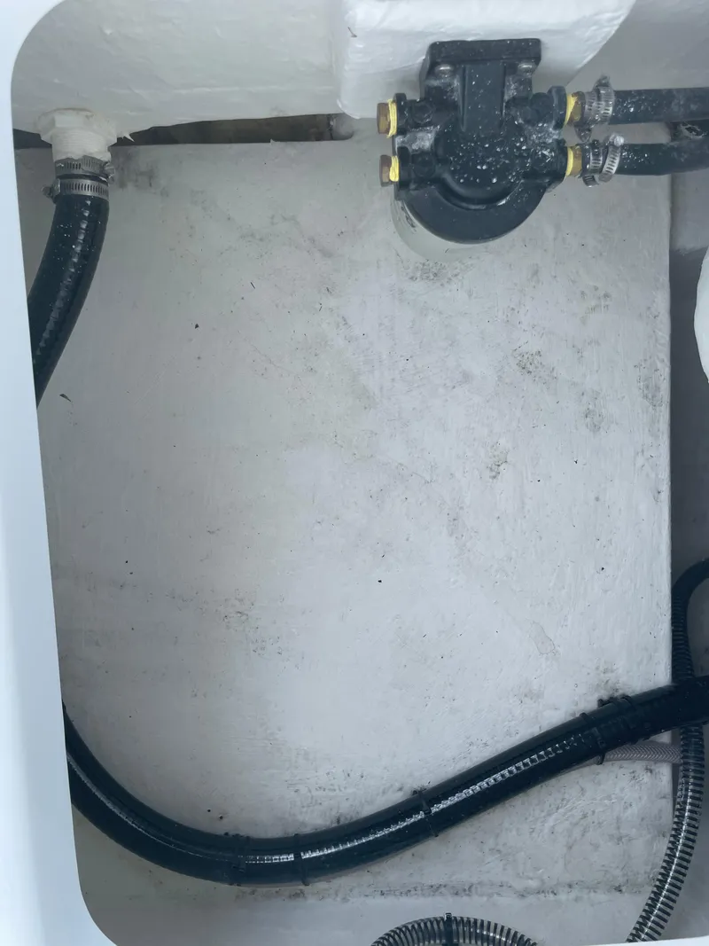 Slide: The Image of 2025 Savannah 210X boat interior with visible hoses and fittings. - 12