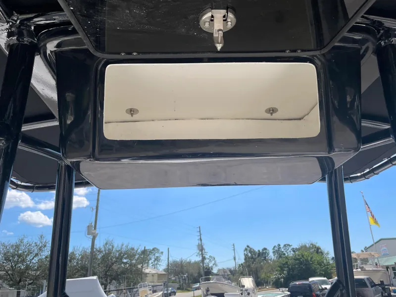 Slide: The Image of 2025 Savannah 210X boat console with storage compartment, under a clear blue sky. - 14