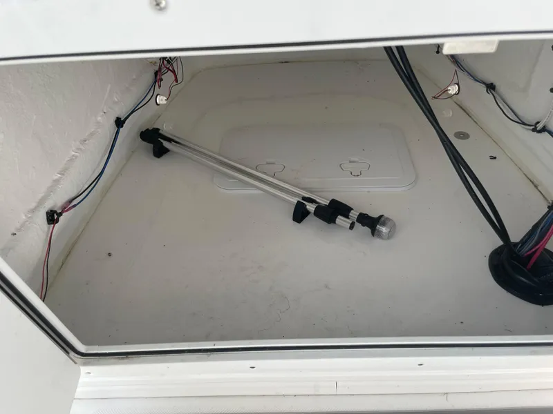 Slide: The Image of Storage compartment of 2025 Savannah 210X with wiring and a metal rod. - 16