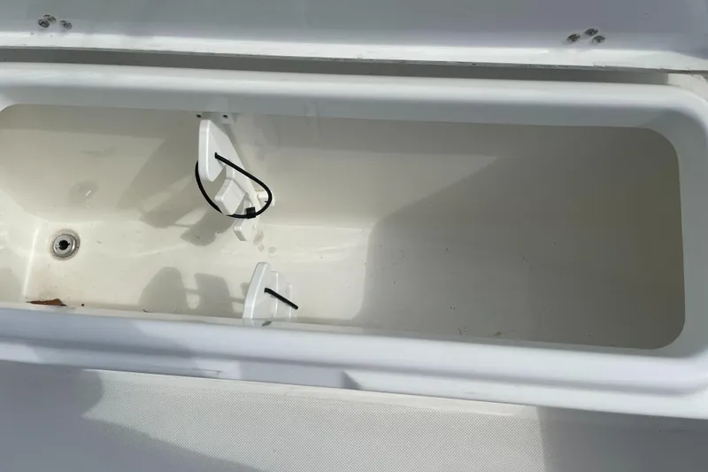 Slide: The Image of Open storage compartment in a 2025 Savannah 210X boat. - 22