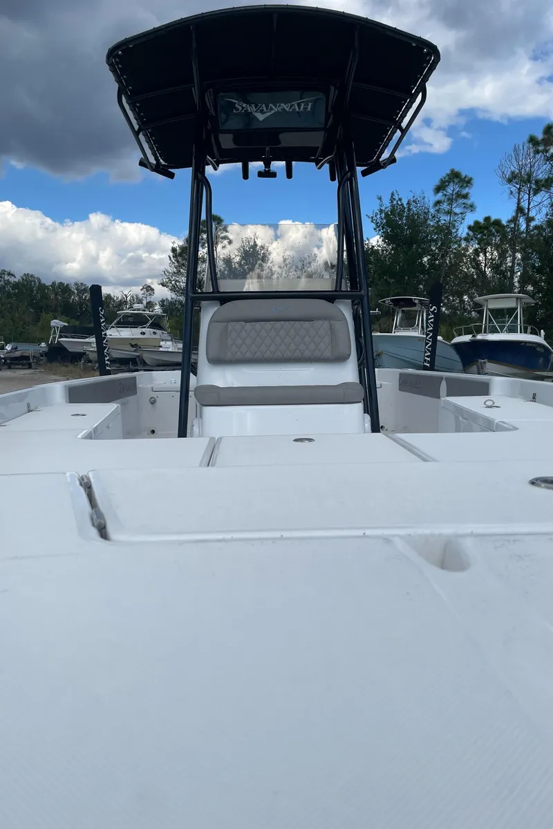 Slide: The Image of 2025 Savannah 210X boat, white deck, T-top, cloudy sky background. - 24