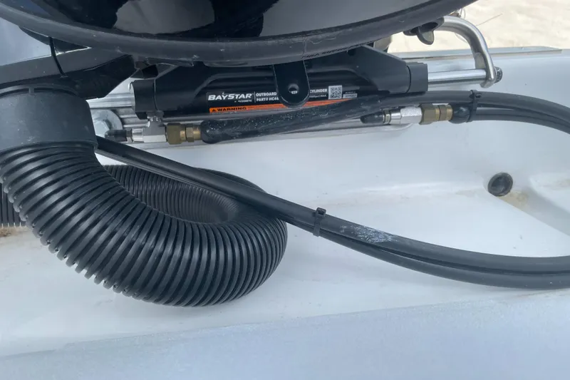 Slide: The Image of Close-up of 2025 Savannah 210X boat steering mechanism and hydraulic hoses. - 25