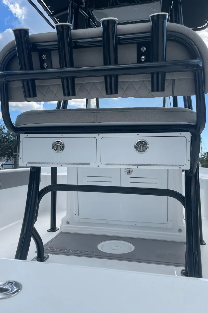 Slide: The Image of 2025 Savannah 210X boat interior with rod holders and storage compartments. - 27