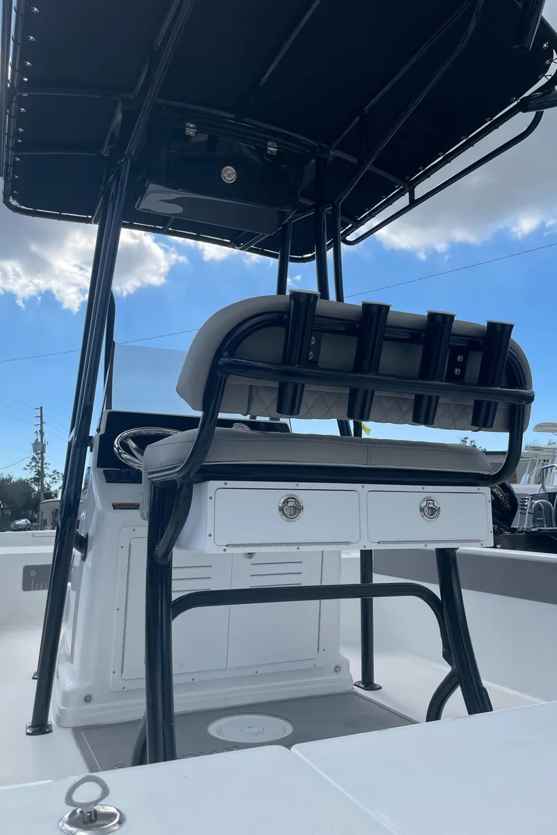 Slide: The Image of 2025 Savannah 210X boat interior with seating and storage under a canopy. - 3