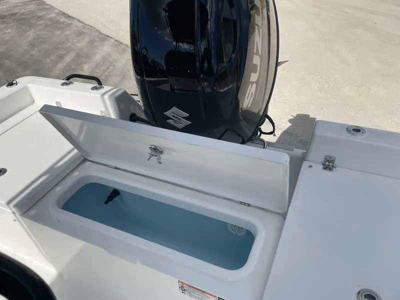 Slide: The Image of 2025 Savannah 210X boat with open storage compartment and Suzuki outboard motor. - 6