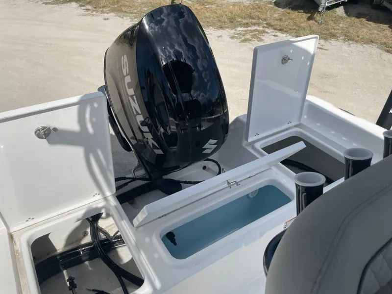 Slide: The Image of 2025 Savannah 210X boat with Suzuki outboard motor and open storage compartments. - 7