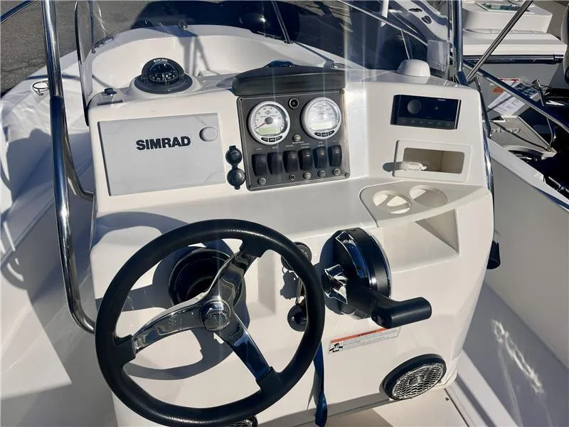 Slide: The Image of Boston Whaler 180 Dauntless 2008 boat console with steering wheel and Simrad electronics. - 3