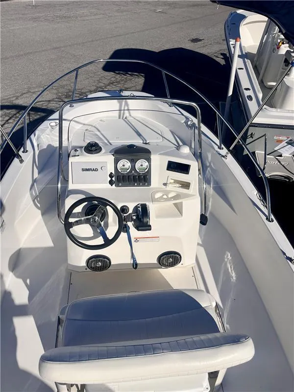 Slide: The Image of 2008 Boston Whaler 180 Dauntless boat interior with steering wheel and control panel. - 4