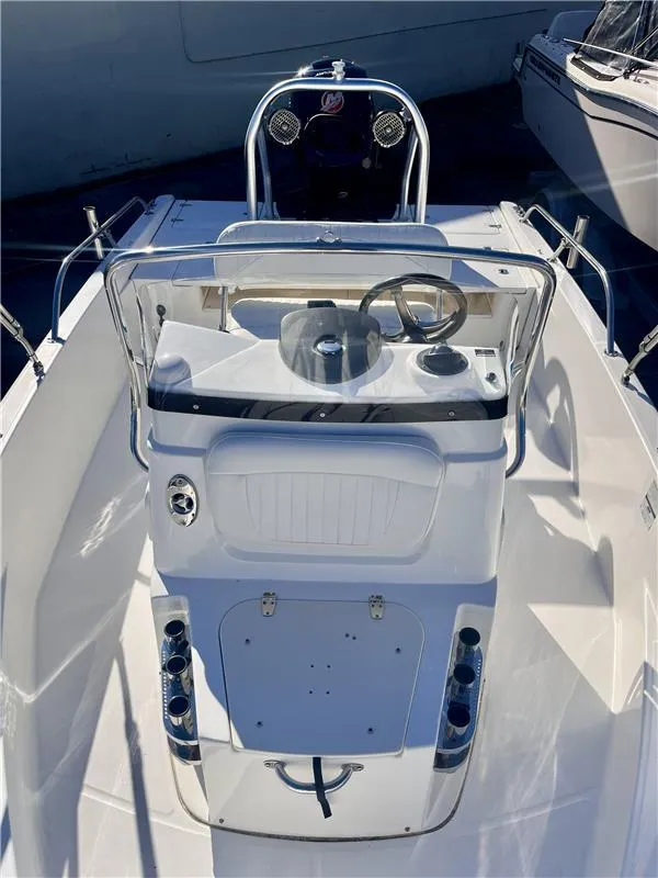 Slide: The Image of 2008 Boston Whaler 180 Dauntless boat console with steering wheel and controls. - 6