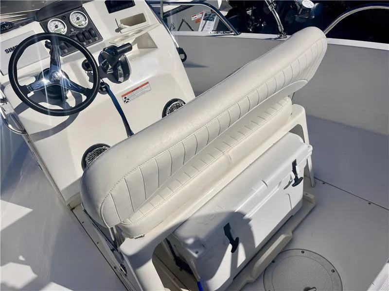 Slide: The Image of 2008 Boston Whaler 180 Dauntless boat interior with steering wheel and cushioned seating. - 7