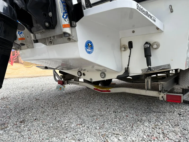 Slide: The Image of 2021 C-Hawk 25 Center Console boat on trailer, rear view, gravel ground. - 20