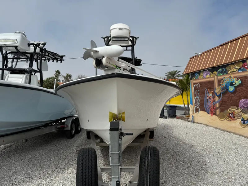 Slide: The Image of 2021 C-Hawk 25 Center Console boat on trailer, parked near colorful mural. - 3