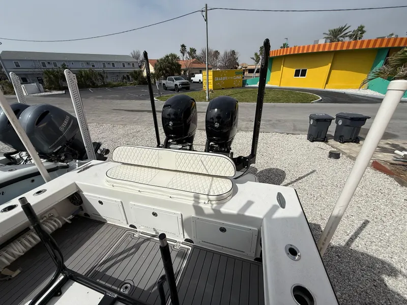 Slide: The Image of 2021 C-Hawk 25 Center Console boat with dual engines, docked on gravel. - 5