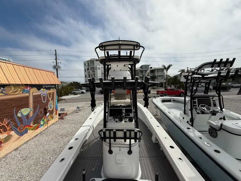 Slide: The Image of 2021 C-Hawk 25 Center Console boat in a coastal setting, showcasing its sleek design. - 8