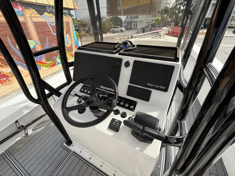 Slide: The Image of 2021 C-Hawk 25 Center Console boat dashboard with Raymarine electronics. - 9