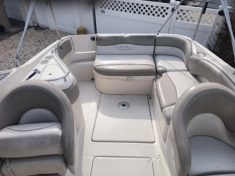 Slide: The Image of 2004 Sea Ray 240 Sundeck interior with spacious seating and clean design. - 3
