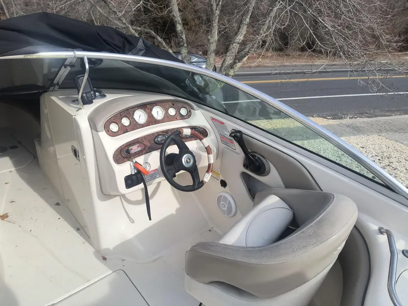 Slide: The Image of 2004 Sea Ray 240 Sundeck boat interior with steering wheel and dashboard controls. - 4