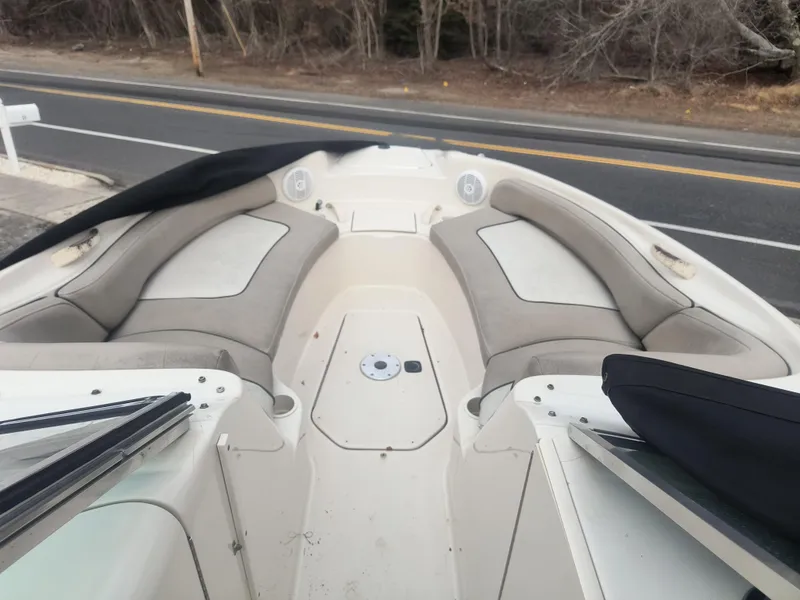 Slide: The Image of 2004 Sea Ray 240 Sundeck boat interior with beige seating and open deck. - 6