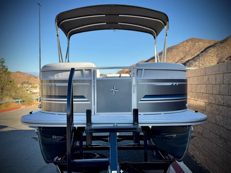 Slide: The Image of 2025 Berkshire 20 CRSE pontoon boat on trailer, scenic mountain backdrop. - 2