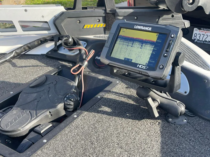 Slide: The Image of Fishfinder and pedal controls on a 2005 Nitro NX 882 DC boat deck. - 10