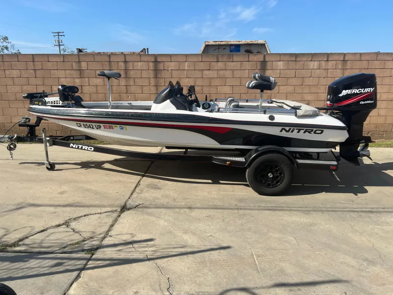 Slide: The Image of 2005 Nitro NX 882 DC fishing boat with Mercury outboard motor, parked on a trailer. - 2