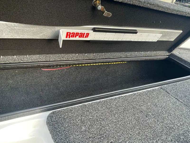 Slide: The Image of 2005 Nitro NX 882 DC boat storage compartment with Rapala measuring tool. - 25