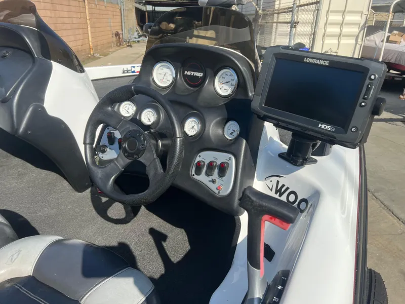 Slide: The Image of 2005 Nitro NX 882 DC boat dashboard with steering wheel and Lowrance HDS-5 fishfinder. - 5