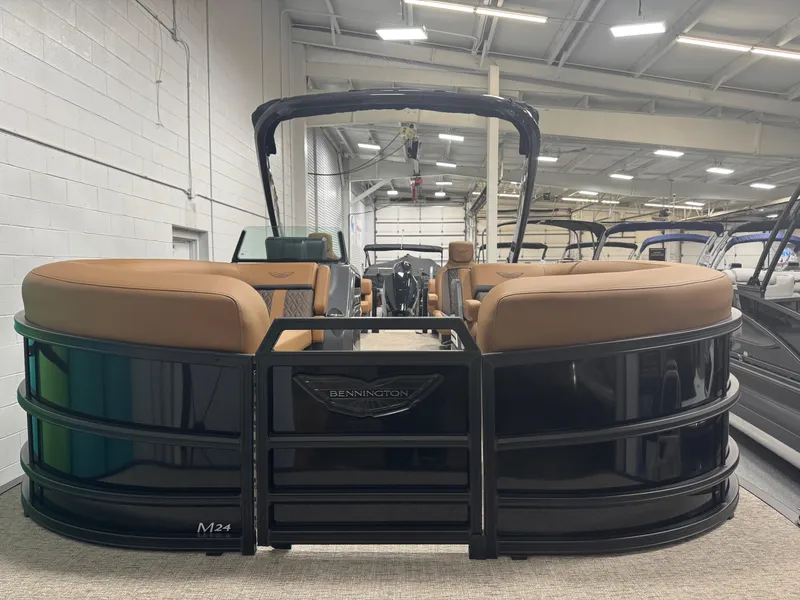 Slide: The Image of 2025 Bennington 24 MFB pontoon boat with sleek black exterior and tan seating. - 1