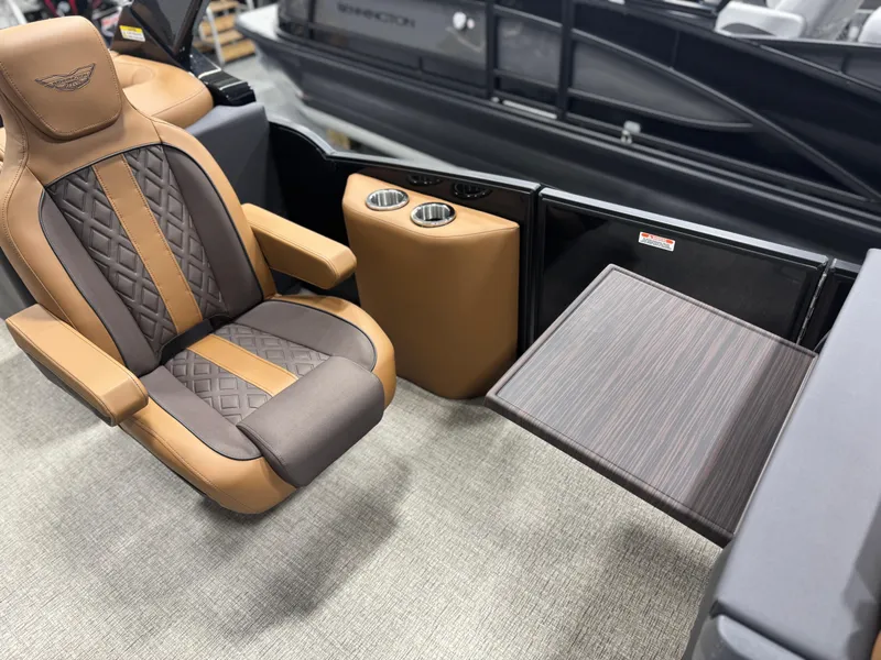 Slide: The Image of 2025 Bennington 24 MFB boat interior with tan seating and carpeted flooring. - 13
