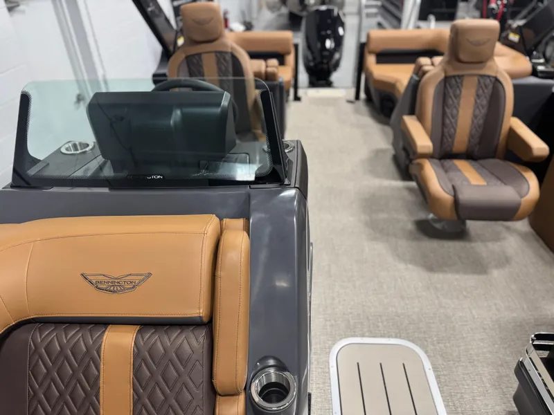 Slide: The Image of Bennington 24 MFB 2025 boat dashboard with steering wheel and digital display. - 15