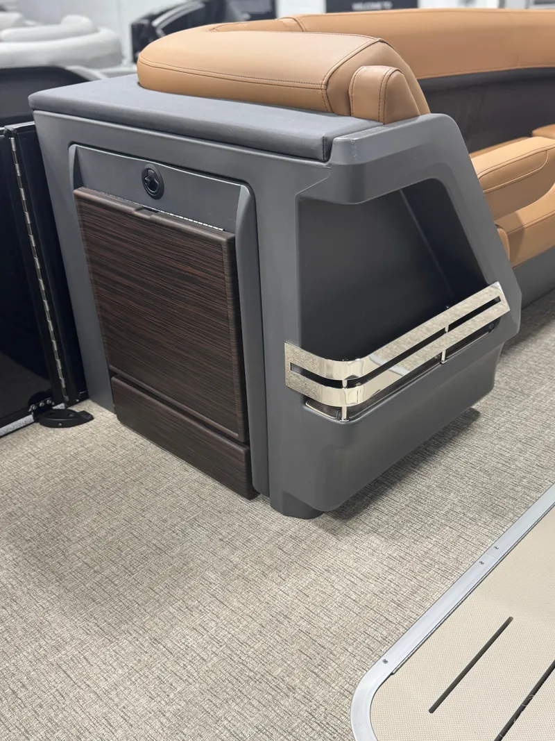 Slide: The Image of 2025 Bennington 24 MFB interior storage compartment with wood finish and open drawer. - 20