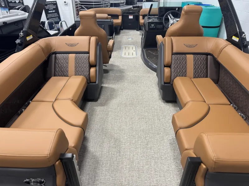 Slide: The Image of 2025 Bennington 24 MFB pontoon boat with tan seating in a showroom. - 4