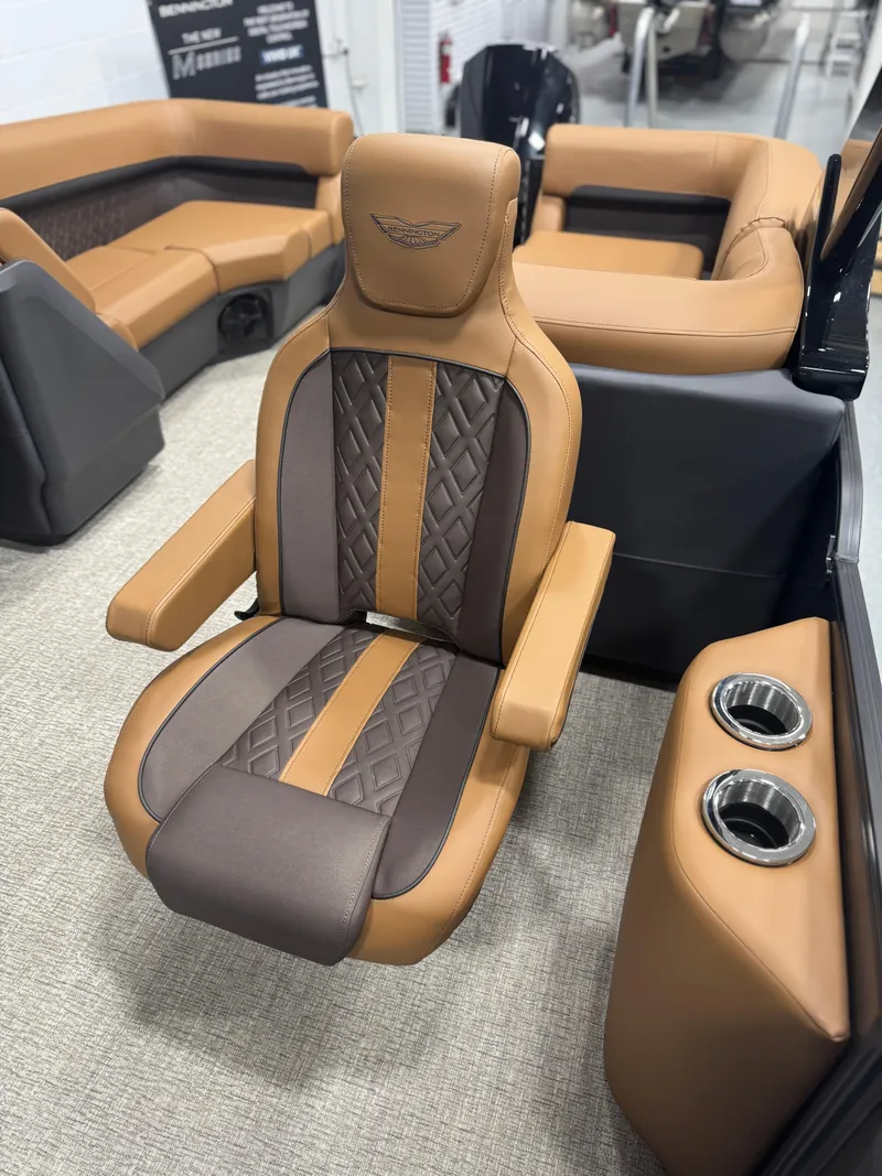 Slide: The Image of 2025 Bennington 24 MFB boat interior with luxurious tan and brown seating. - 6