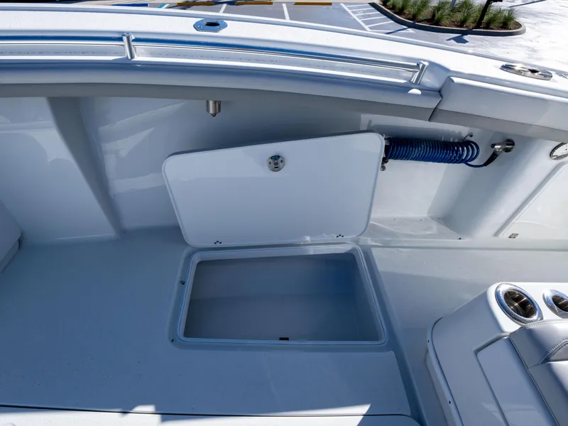 Slide: The Image of 2023 Yellowfin 36 Center Console boat deck with storage compartment and hose. - 18