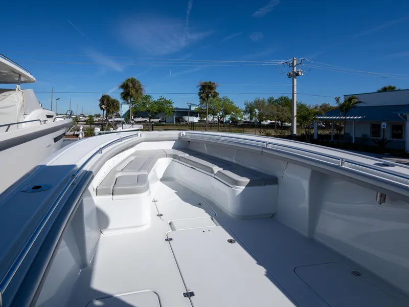 Slide: The Image of 2023 Yellowfin 36 Center Console boat with spacious seating and sleek design under clear blue sky. - 20