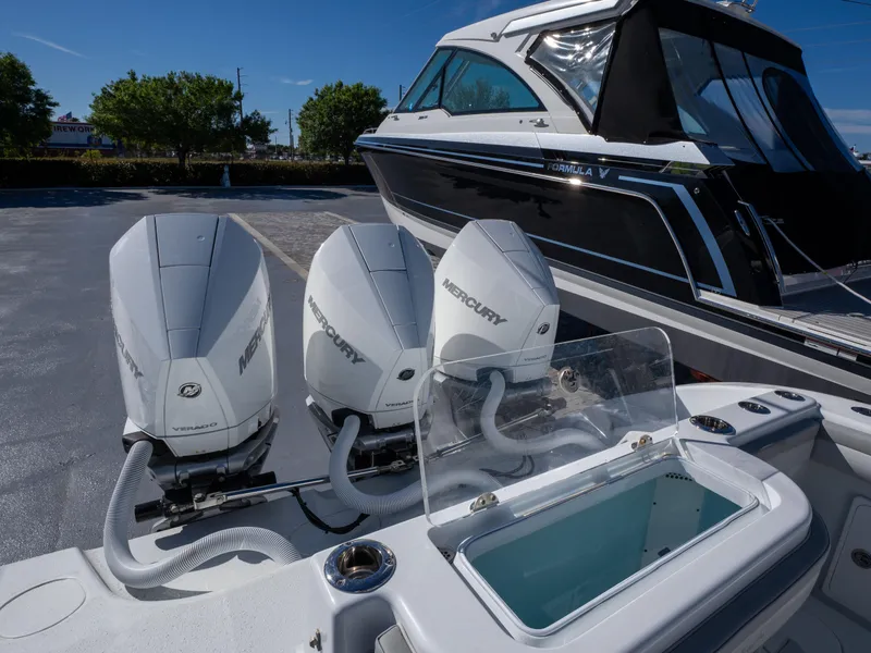Slide: The Image of 2023 Yellowfin 36 Center Console with triple Mercury outboard engines, docked beside another boat. - 23