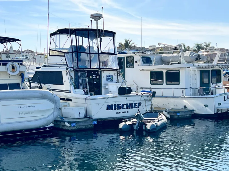 The Image of 1982 Silverton 37 Convertible boat named "Mischief" docked at marina. - 0