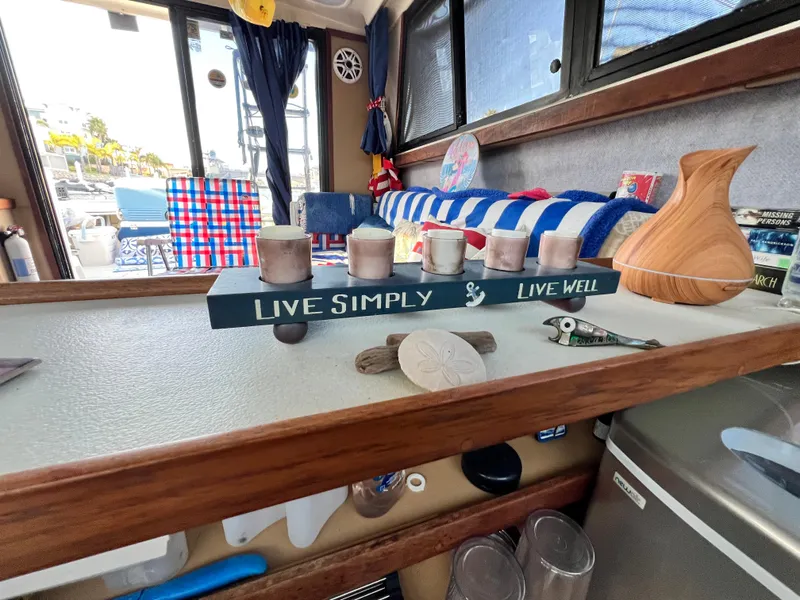 Slide: The Image of Interior of 1982 Silverton 37 Convertible with nautical decor and "Live Simply, Live Well" sign. - 14