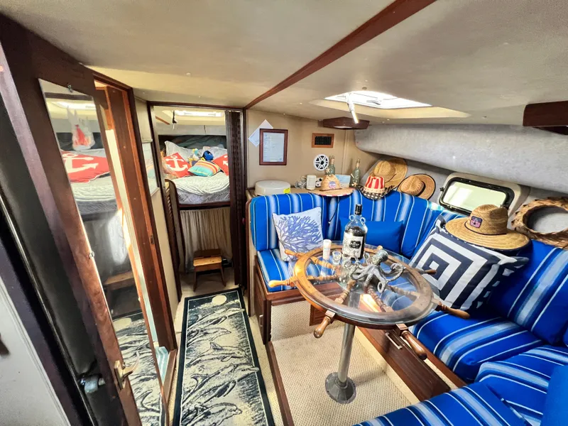 Slide: The Image of Interior of 1982 Silverton 37 Convertible with blue-striped seating and nautical decor. - 15