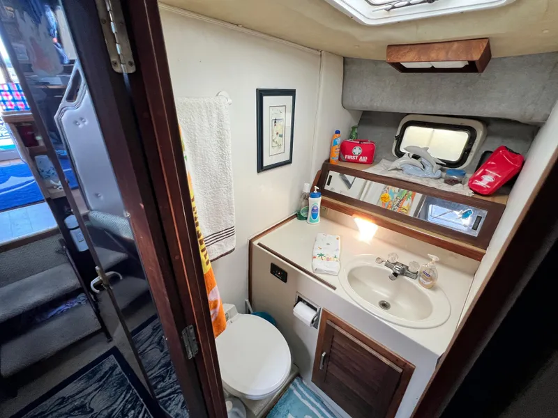 Slide: The Image of 1982 Silverton 37 Convertible boat bathroom with sink, mirror, and storage. - 20