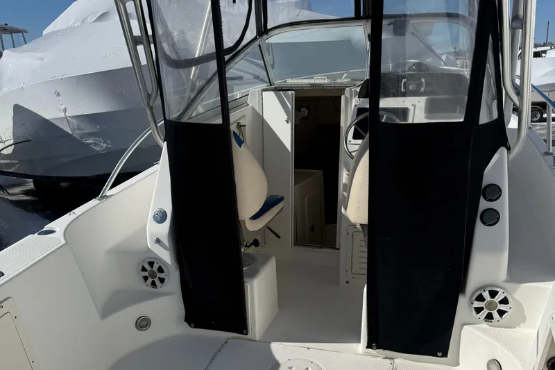 Slide: The Image of 2000 Mako 253 Walk Around boat interior with seating and steering area. - 10