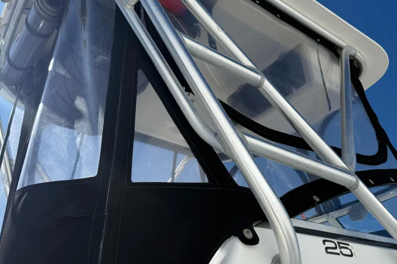 Slide: The Image of Close-up of a 2000 Mako 253 Walk Around boat's cabin and metal framework. - 13