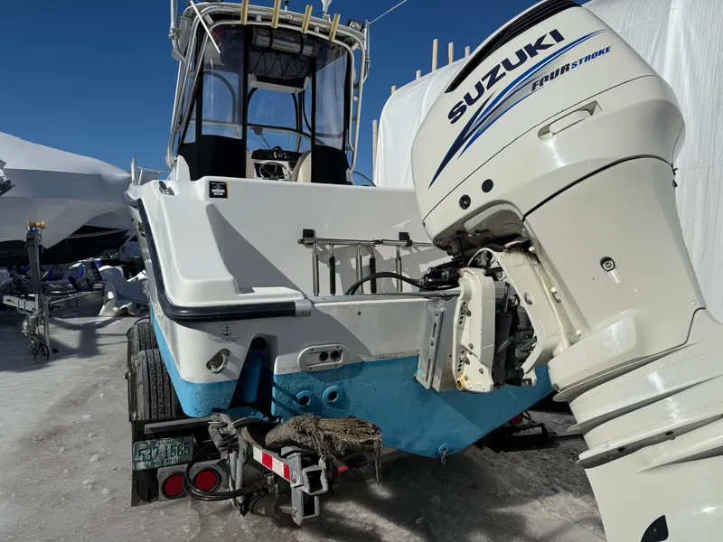 Slide: The Image of 2000 Mako 253 Walk Around boat with Suzuki outboard motor on trailer. - 4