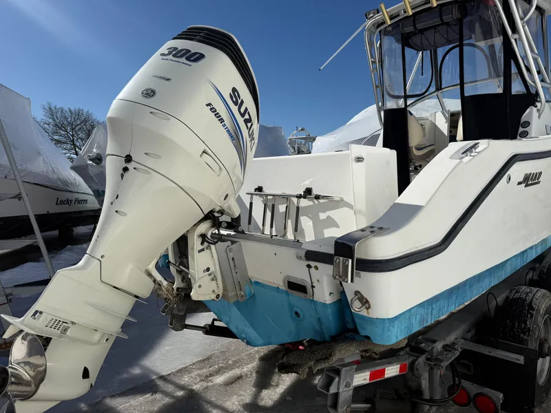 Slide: The Image of 2000 Mako 253 Walk Around boat with Suzuki 300 outboard motor in a snowy setting. - 5