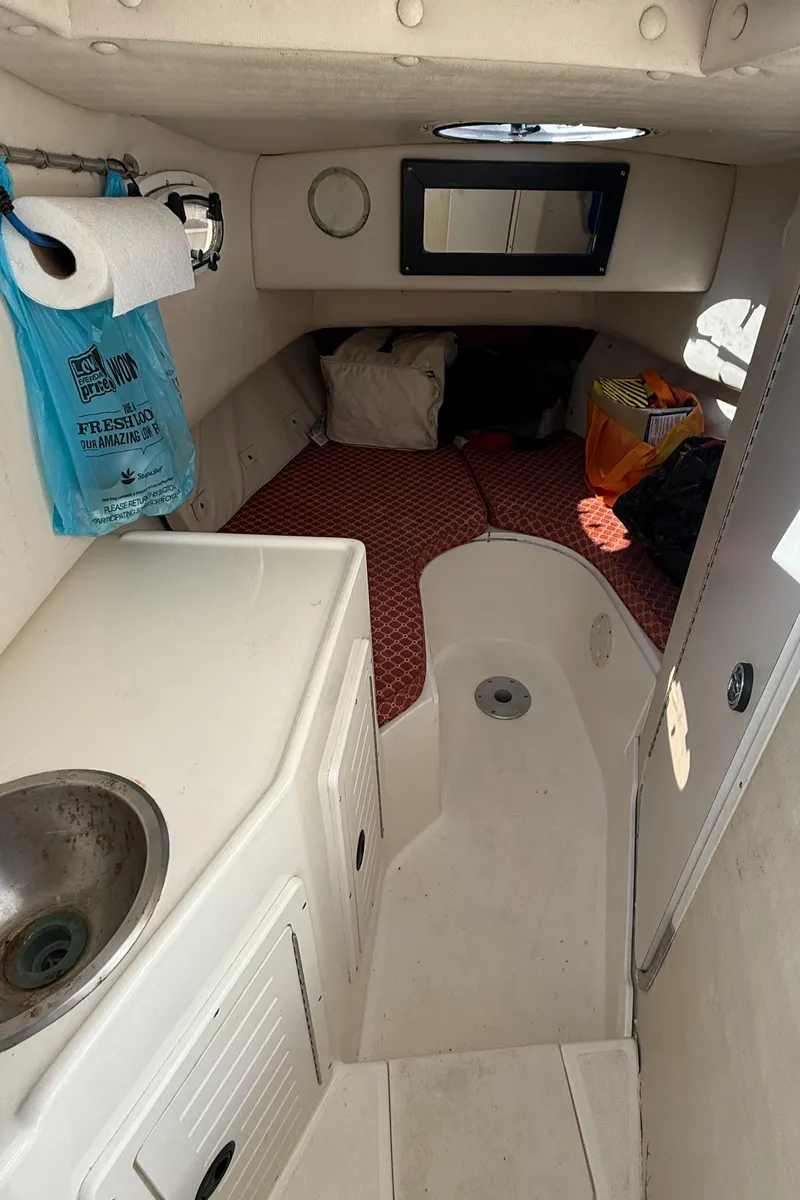 Slide: The Image of Interior cabin of a 2000 Mako 253 Walk Around boat with sink and sleeping area. - 8