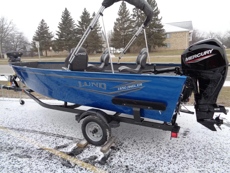 The Image of 2024 Lund 1650 Angler Tiller boat with Mercury engine on a snowy day. - 0