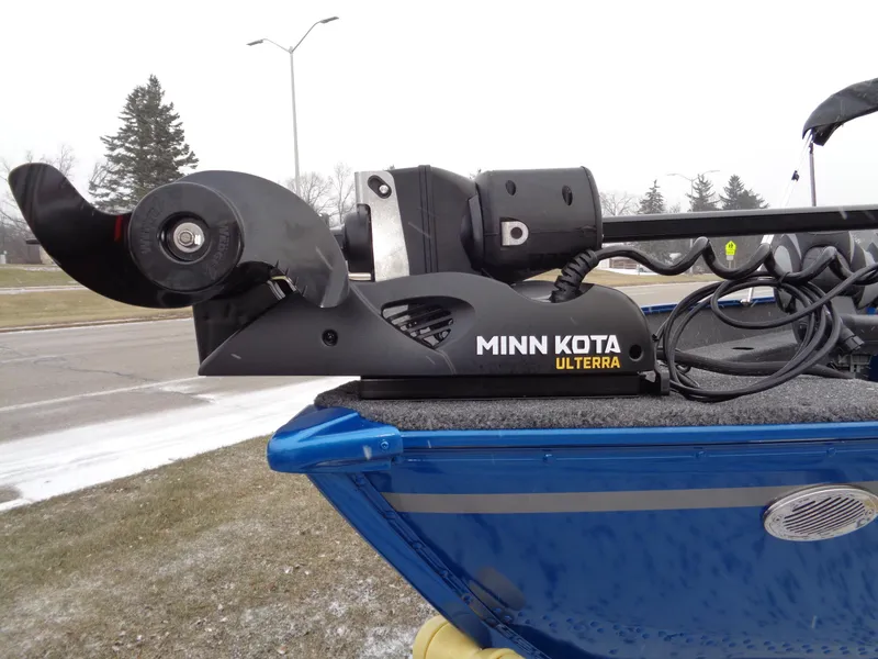 Slide: The Image of 2024 Lund 1650 Angler Tiller with Minn Kota Ulterra motor on a snowy day. - 2
