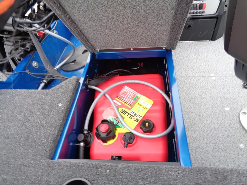 Slide: The Image of 2024 Lund 1650 Angler Tiller boat fuel compartment with red fuel tank and hose. - 8