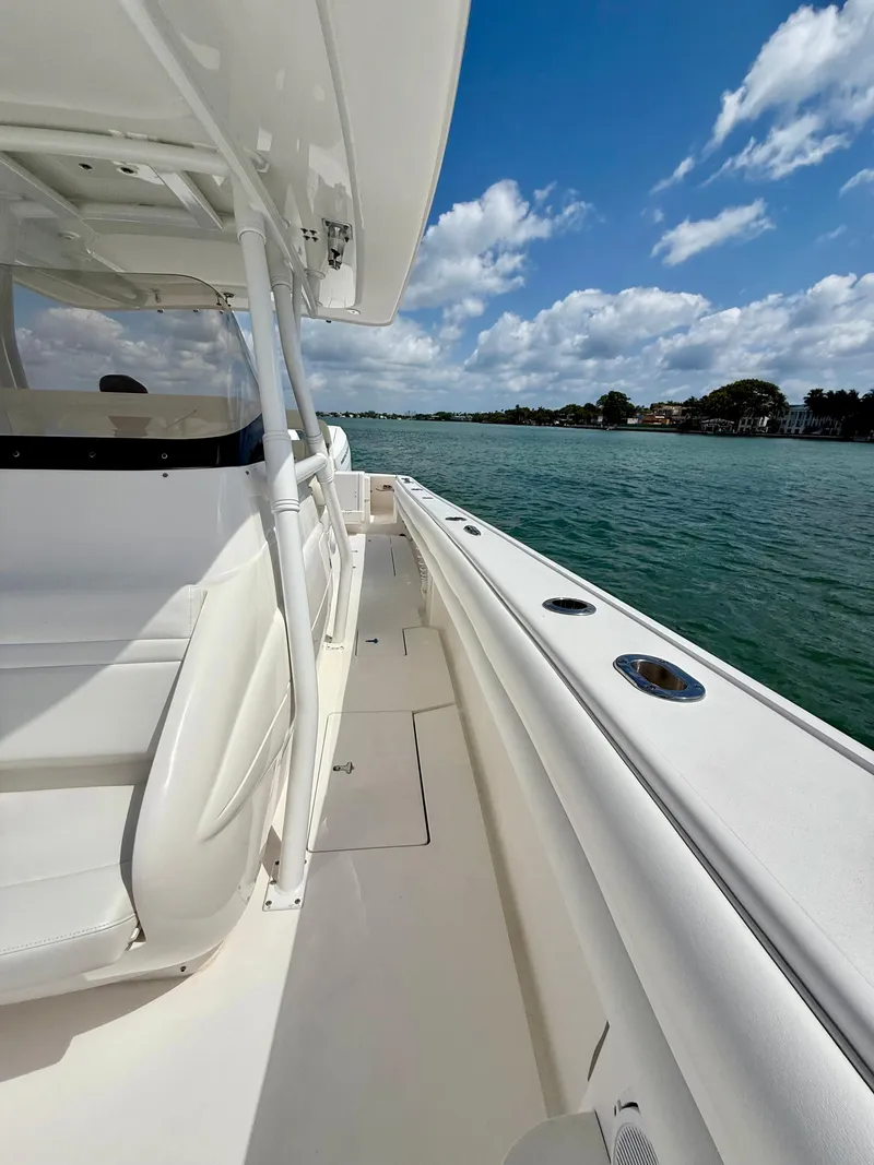 Slide: The Image of 2015 Intrepid 375 Center Console boat on calm water under a blue sky. - 22
